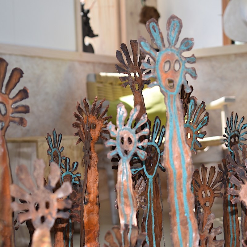 An array of copper Mimi faces