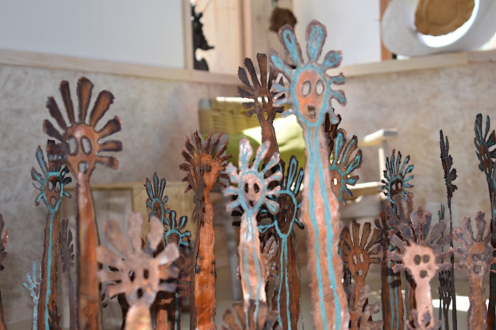 An array of copper Mimi faces