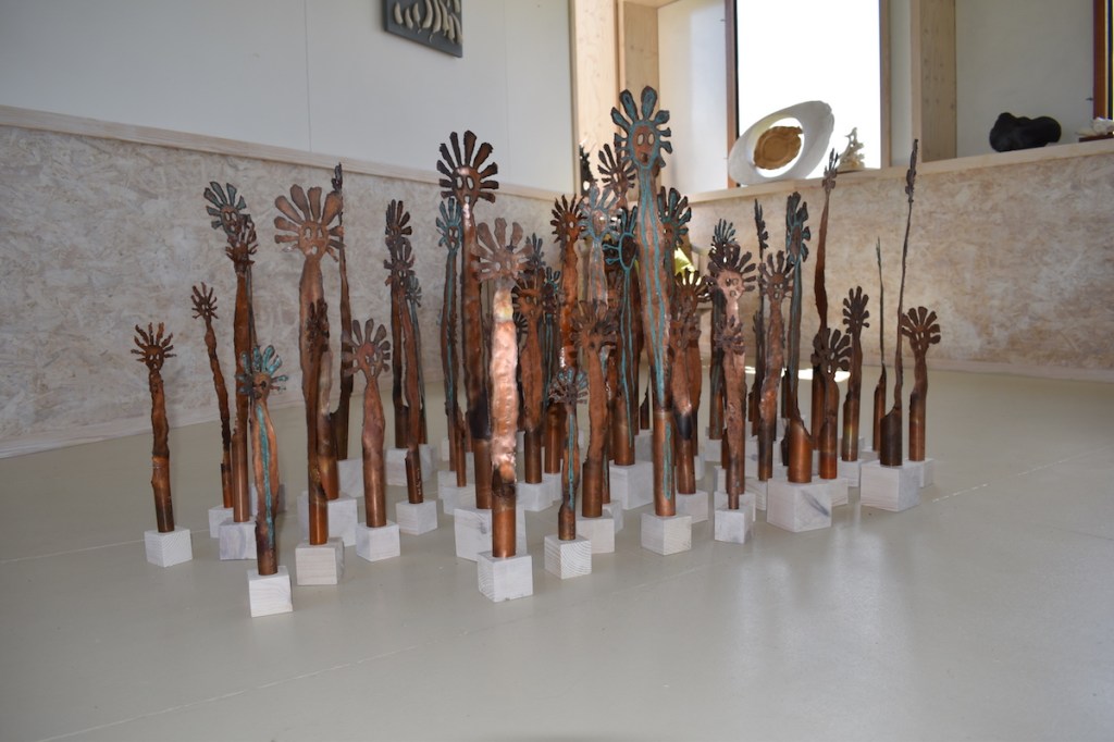 A grouping of about 60 copper Mimi figures on show.