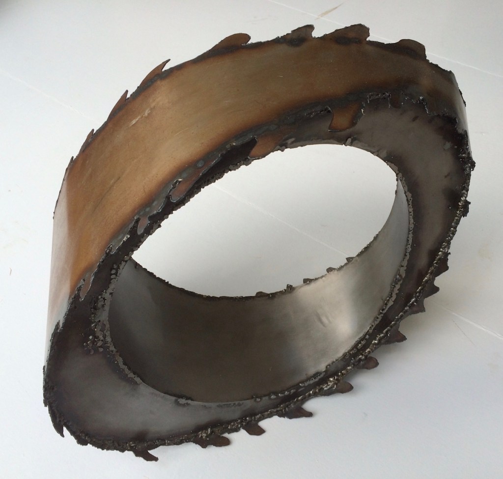 Germaine - Mildsteel jagged edge ovoid wedge with circular hollow inner.