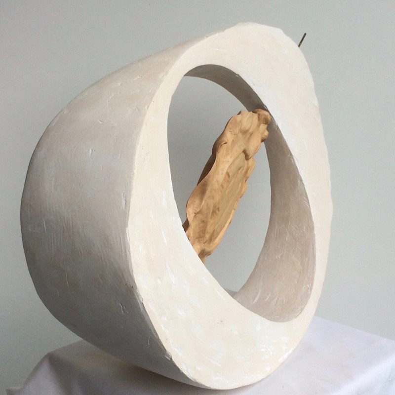 Barbara Seed - Plaster of Paris elliptical wedge with circular hollow and carved wooden seed in hollow. this sculpture references and honours the work of British sculptor Barbara Hepworth.